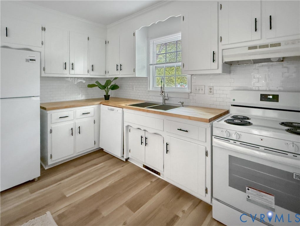 3203 Roland View Terrace, Chester, VA 23831 White cabinetry with matte black hardware, wood-finish countertops, white subway tile backsplash, and light wood-finish flooring