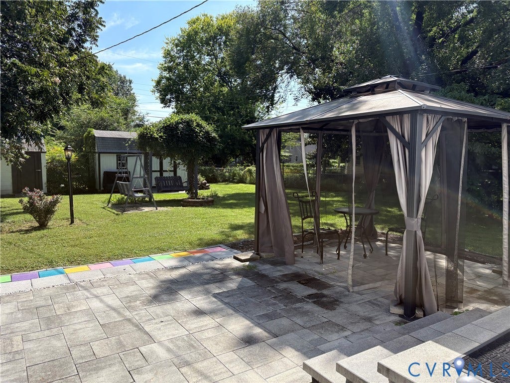 6211 Clover Lane, Lakeside, Henrico, VA 23228 Expansive backyard oasis featuring a paver patio, freestanding gazebo with integrated screens and drapes, mature shade trees, and manicured lawn
