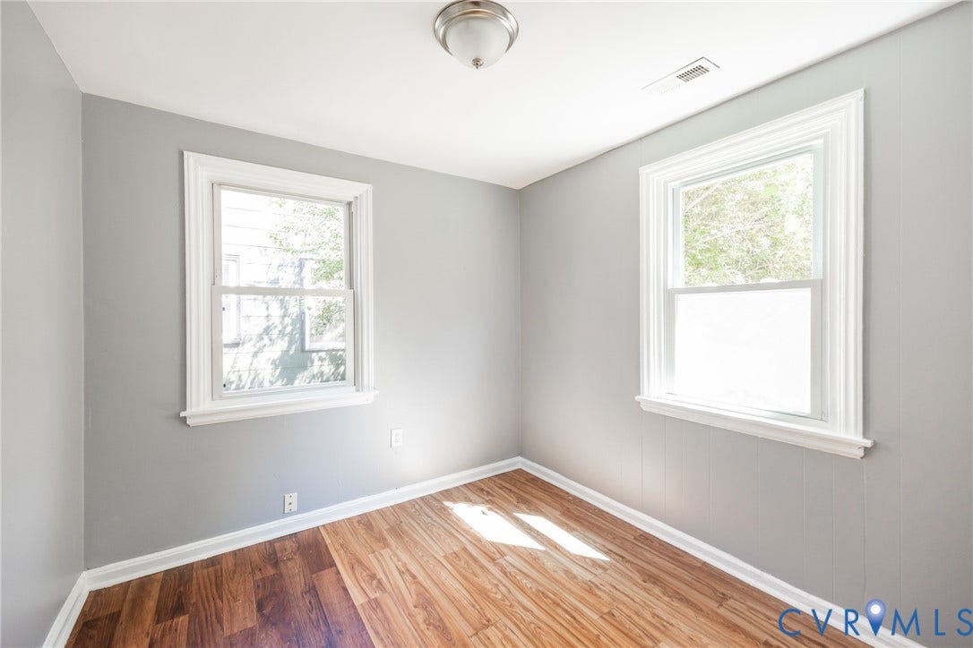 3505 Meadowbridge Road, Richmond, VA 23222 Bright corner bedroom flooded with natural light from two large double-hung windows featuring white trim