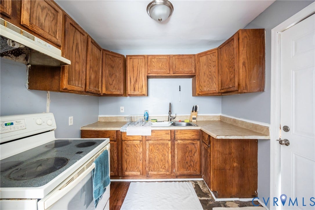3505 Meadowbridge Road, Richmond, VA 23222 Efficient galley kitchen featuring warm wood cabinetry, laminate countertops with undermount sink, white appliances, and ceramic tile flooring