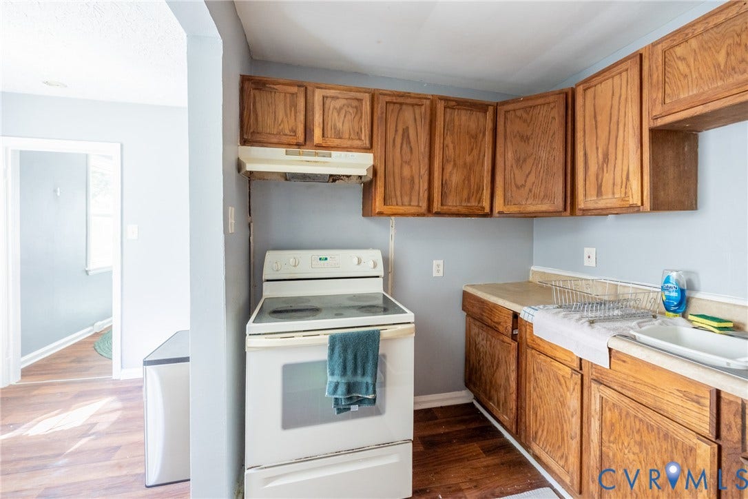 3505 Meadowbridge Road, Richmond, VA 23222 Kitchen featuring wood-finish cabinetry, a freestanding range, and a single-basin sink