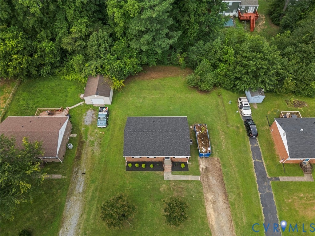 3924 Lamplighter Drive, Richmond, VA 23234 Brick residence with a dark shingle roof and surrounding green lawn