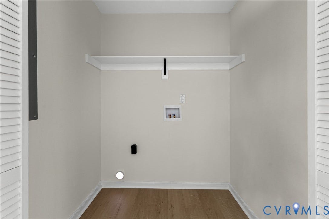 3924 Lamplighter Drive, Richmond, VA 23234 Dedicated utility space featuring wood-finish flooring, light neutral wall tones, a built-in storage shelf, and louvered doors