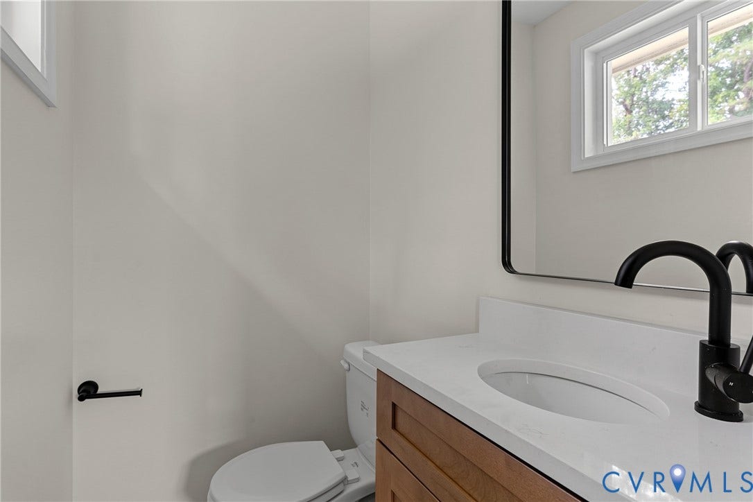 3924 Lamplighter Drive, Richmond, VA 23234 Bathroom vanity featuring a white countertop, oval undermount sink, and matte black faucet