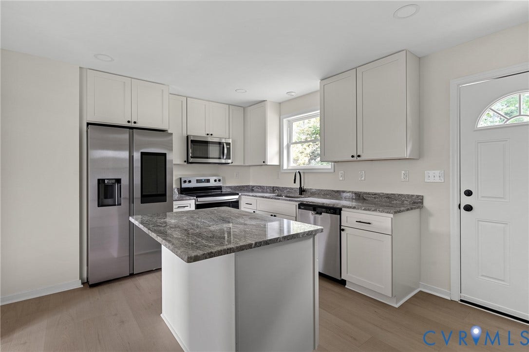 3924 Lamplighter Drive, Richmond, VA 23234 Kitchen featuring light-toned cabinetry, stainless steel appliances, and wood-finish flooring