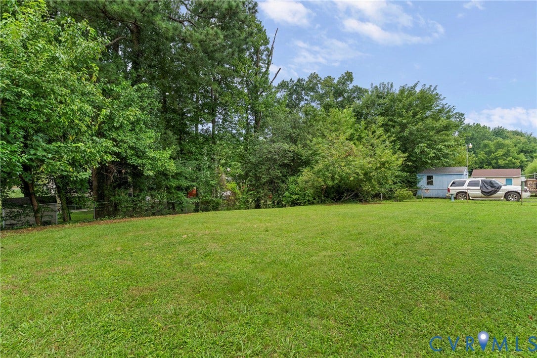 3924 Lamplighter Drive, Richmond, VA 23234 Expansive grassy area with mature trees framing the perimeter