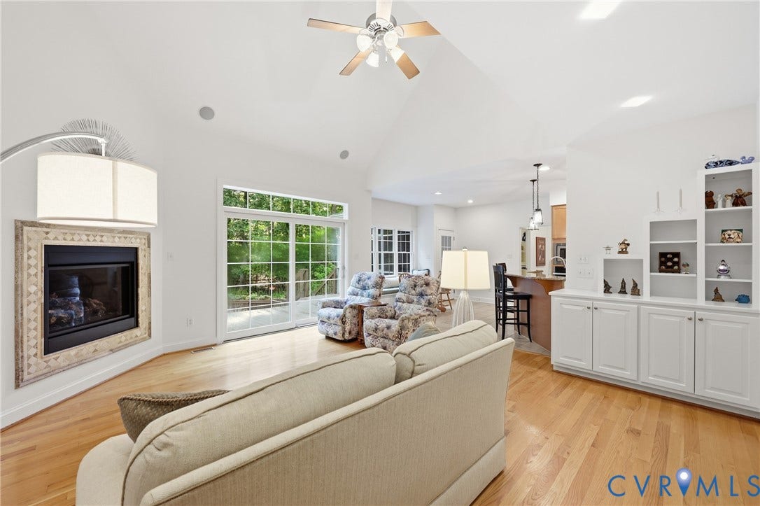 2431 Magnolia Ridge, Michael L Parrish, Maidens, VA 23102 Sliding glass doors offer access to the deck while the fireplace adds warmth and built-in storage adds a bit of character.