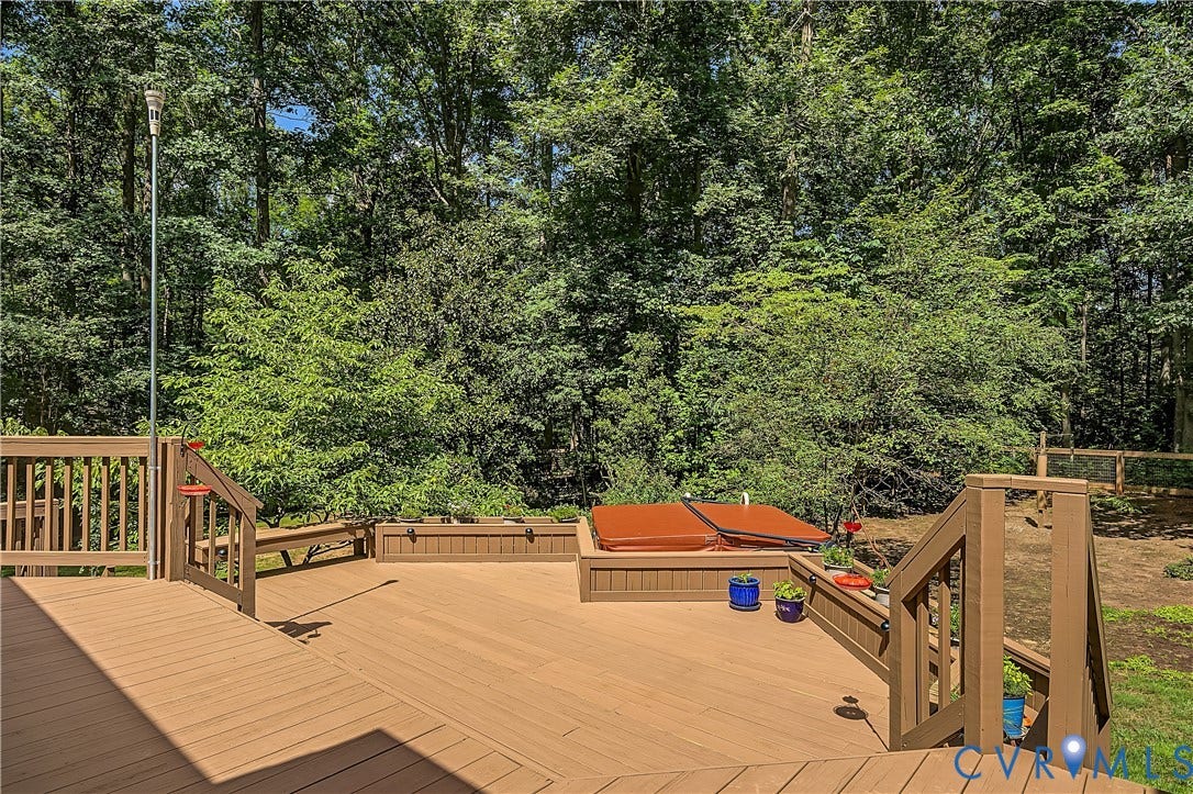 2431 Magnolia Ridge, Michael L Parrish, Maidens, VA 23102 Freshly painted three-tier deck surrounded by wooded scenery