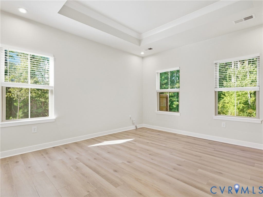 8060 Wistar Glen Drive, Henrico, VA 23228 Generous primary bedroom with durable LVP flooring and view of the backyard