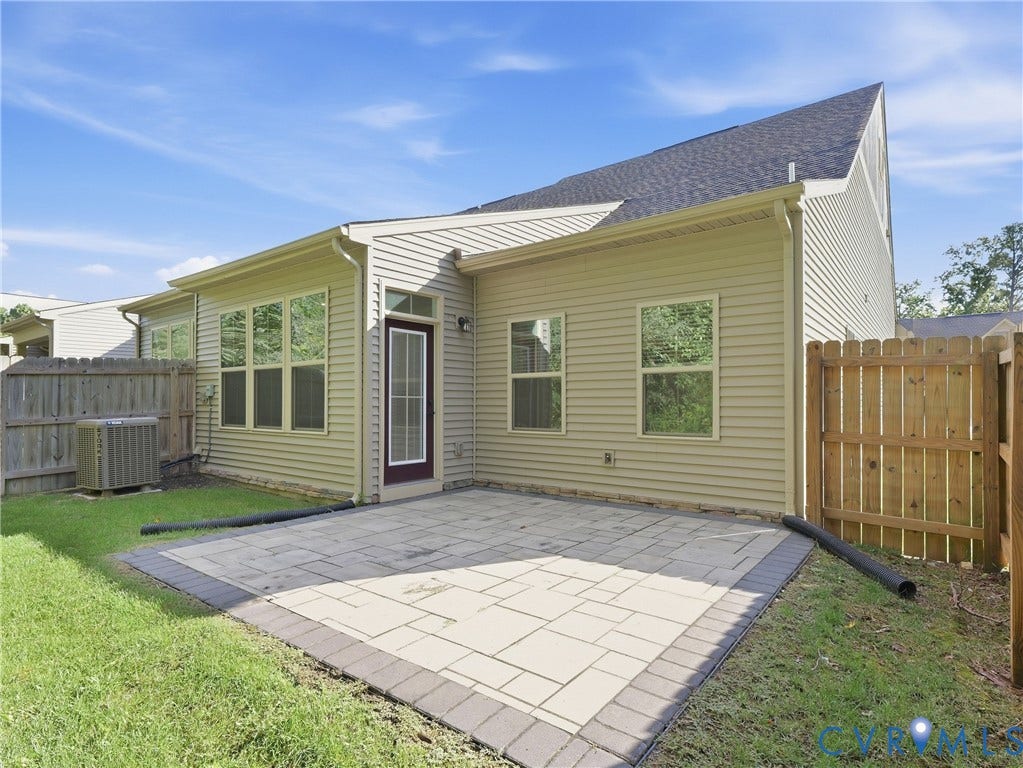 8060 Wistar Glen Drive, Henrico, VA 23228 Partially fenced backyard with a stone patio for outdoor gatherings