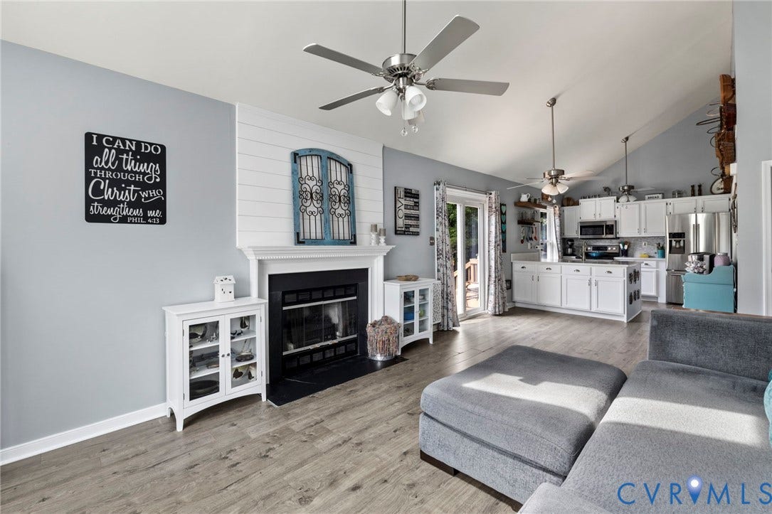 10138 Alberta Circle, Chesterfield, VA 23832 Vaulted ceiling with ceiling fans, wood-finish flooring, fireplace with mantel, white cabinetry, and sliding glass door