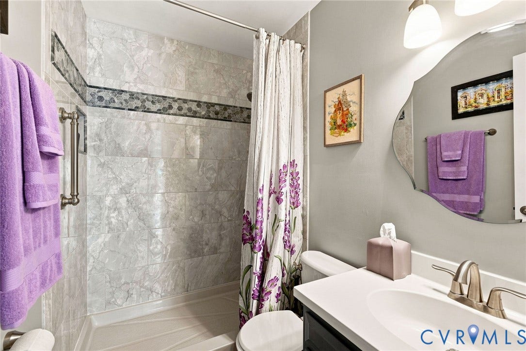 10138 Alberta Circle, Chesterfield, VA 23832 Shower with tiled walls, decorative tile band, and grab bar