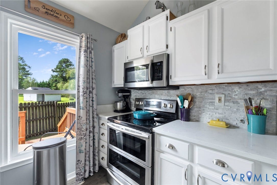 10138 Alberta Circle, Chesterfield, VA 23832 White cabinetry with brushed nickel hardware, stainless steel appliances, light-toned stone backsplash, and solid surface countertops