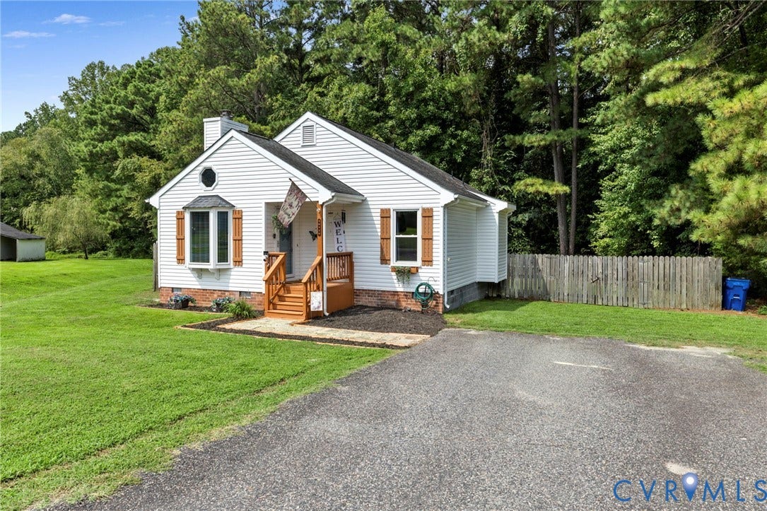 10138 Alberta Circle, Chesterfield, VA 23832 White siding exterior with a wood-finish front porch, bay window, and circular attic window