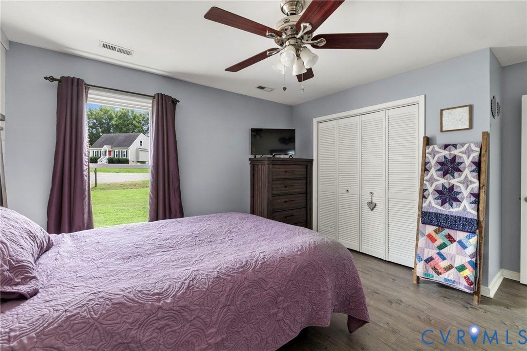 10138 Alberta Circle, Chesterfield, VA 23832 Wood-finish flooring, ceiling fan with integrated lighting, white bi-fold closet doors, and light gray wall paint