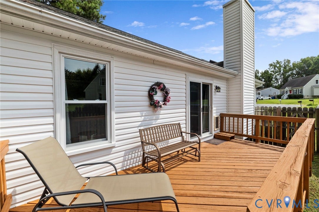 10138 Alberta Circle, Chesterfield, VA 23832 Expansive wood deck with a privacy fence, featuring white vinyl siding, a single-hung window, and a sliding glass door