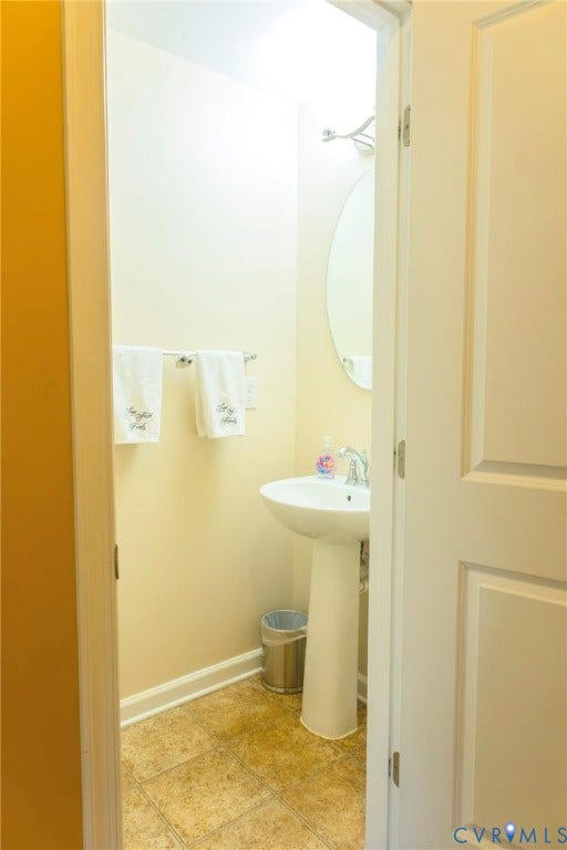 11617 Vicars Ridge Lane, Glen Allen, VA 23059 Pedestal sink with chrome faucet, oval wall mirror, and tile flooring