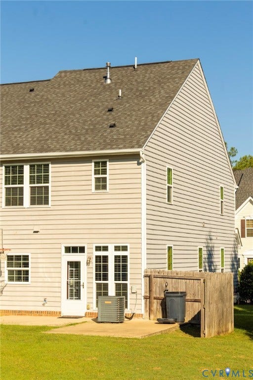 11617 Vicars Ridge Lane, Glen Allen, VA 23059 Pitched roof with asphalt shingles, light-toned siding, multiple windows, a rear entry door, and a concrete patio
