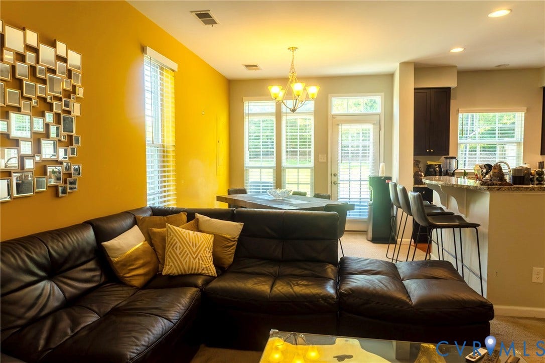 11617 Vicars Ridge Lane, Glen Allen, VA 23059 Open-concept living area with a dining space, kitchen, and ample natural light from multiple windows