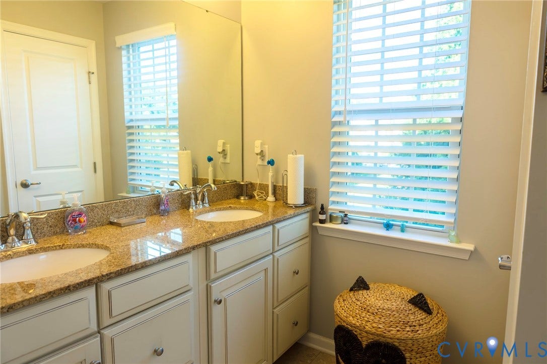 11617 Vicars Ridge Lane, Glen Allen, VA 23059 Dual undermount sinks set into a spacious vanity with a stone-finish countertop