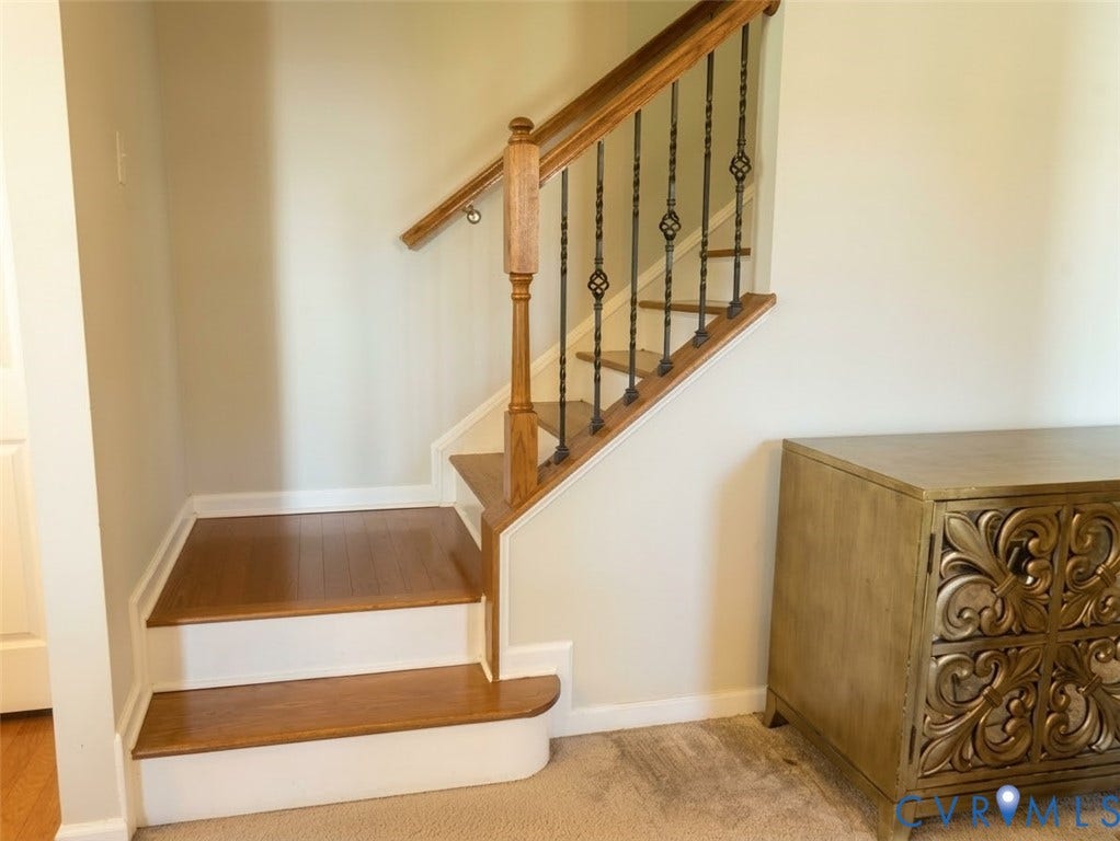 11617 Vicars Ridge Lane, Glen Allen, VA 23059 Staircase featuring wood-finish treads, a wood handrail, and decorative iron balusters