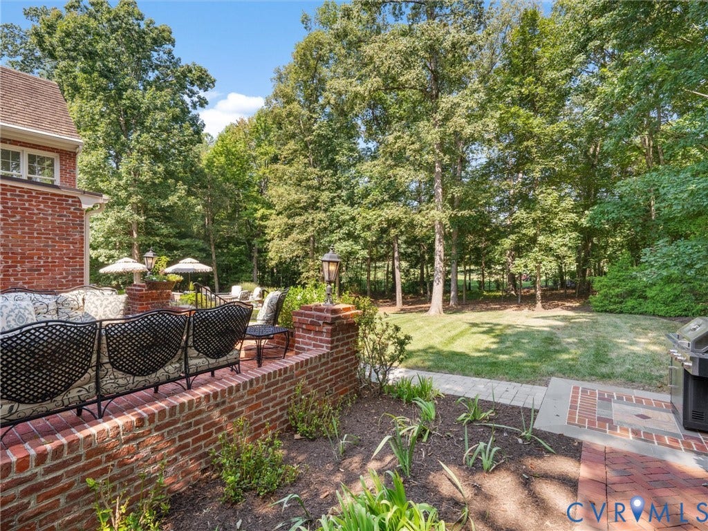 500 Kilmarnock Drive, Collegiate Area, Henrico, VA 23229 Brick exterior featuring multiple windows, a manicured lawn, and mature trees