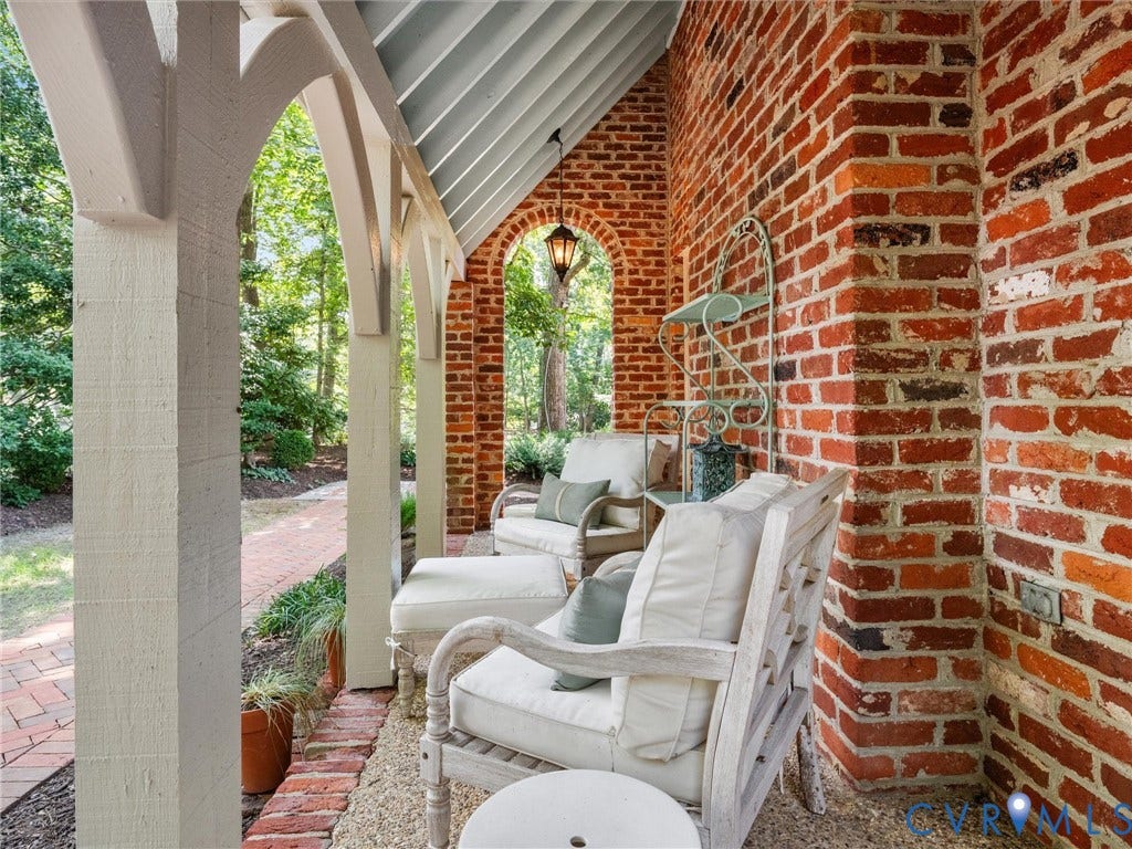 500 Kilmarnock Drive, Collegiate Area, Henrico, VA 23229 Brick exterior wall with an arched opening and a hanging lantern fixture