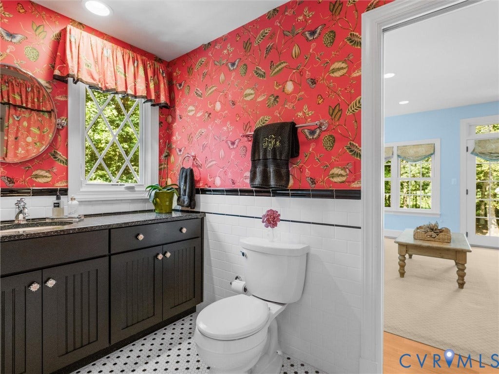 500 Kilmarnock Drive, Collegiate Area, Henrico, VA 23229 Bathroom featuring an ornate pattern wallpaper, black vanity with an integrated sink, diamond-pattern window, and geometric floor tiling