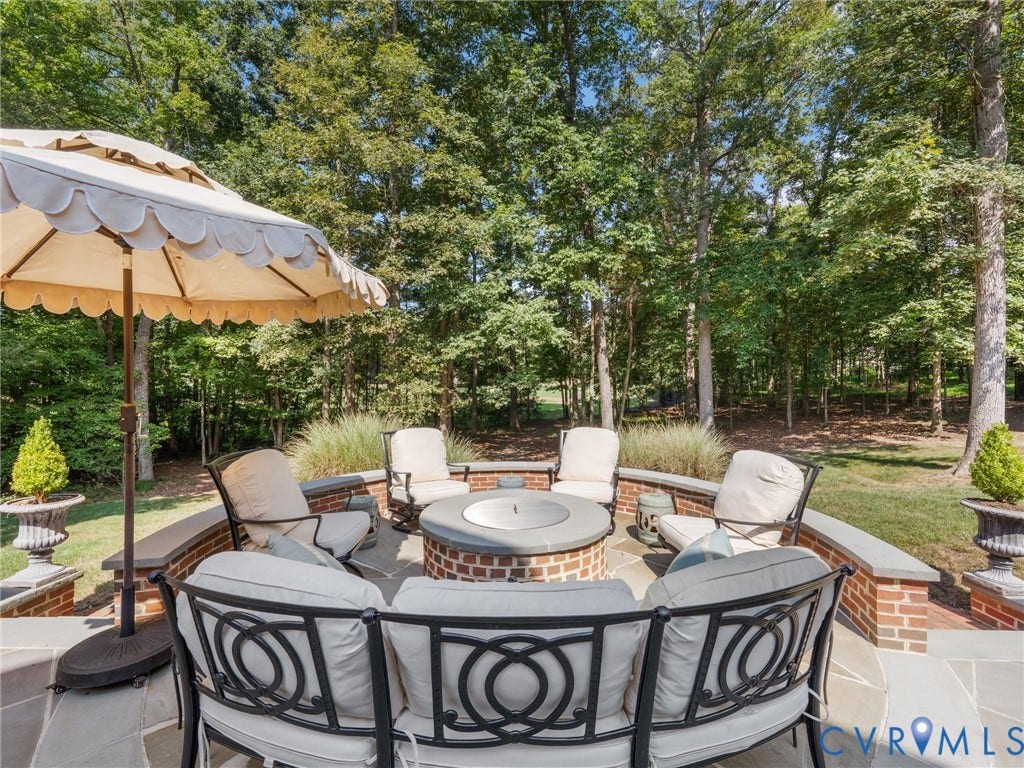 500 Kilmarnock Drive, Collegiate Area, Henrico, VA 23229 Stone patio with a built-in brick fire pit and surrounding brick wall