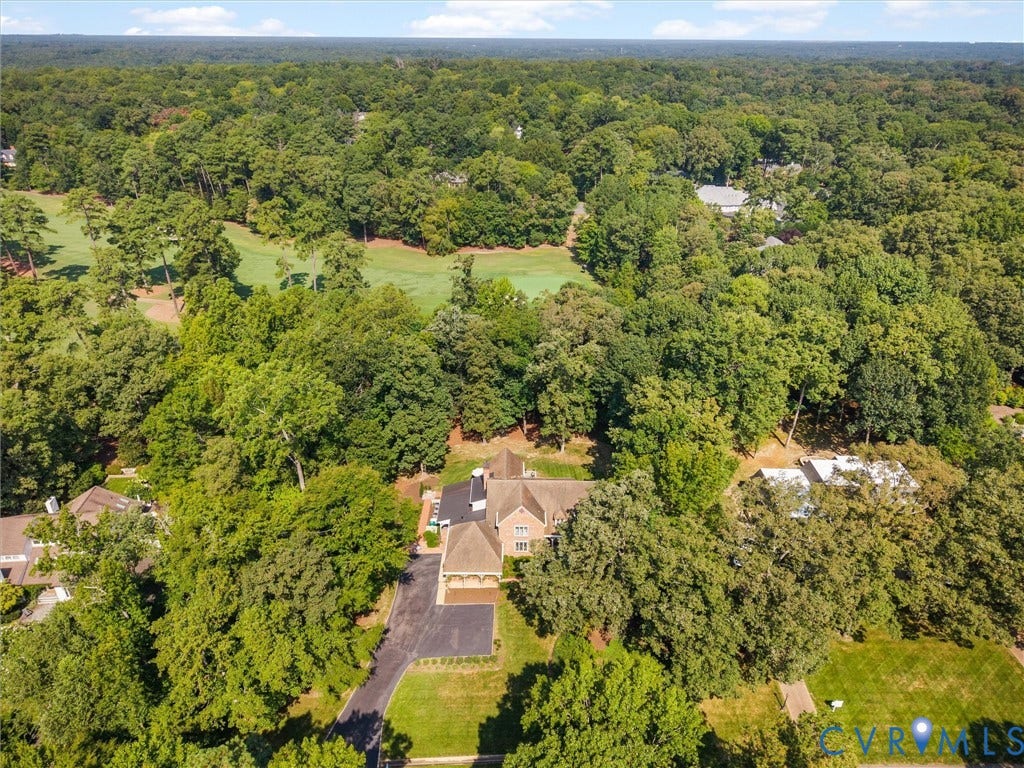 500 Kilmarnock Drive, Collegiate Area, Henrico, VA 23229 Expansive property surrounded by mature trees, featuring a paved driveway, and a golf course beyond