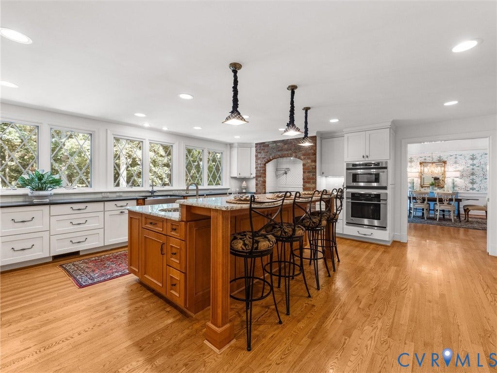 500 Kilmarnock Drive, Collegiate Area, Henrico, VA 23229 Wood-finish flooring, white cabinetry, granite countertops, built-in stainless steel appliances, and a central island with seating