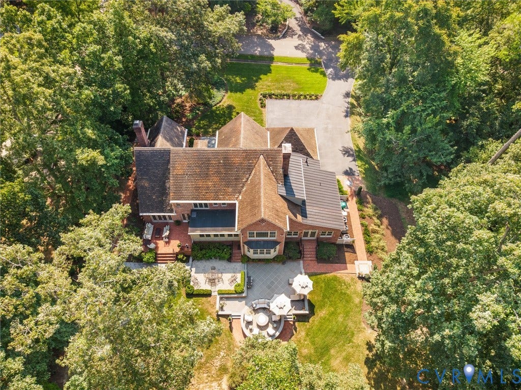 500 Kilmarnock Drive, Collegiate Area, Henrico, VA 23229 Brick exterior with multiple gabled roofs, extensive paved driveway, and multiple outdoor patio areas