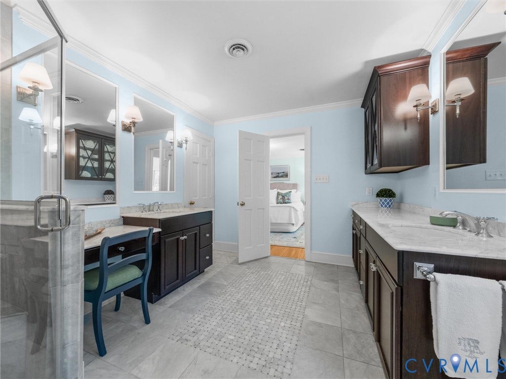 500 Kilmarnock Drive, Collegiate Area, Henrico, VA 23229 Dual dark wood vanities with undermount sinks, stone countertops, and wall-mounted lighting fixtures