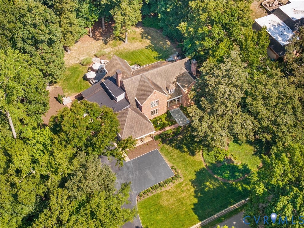 500 Kilmarnock Drive, Collegiate Area, Henrico, VA 23229 Brick exterior residence featuring a multi-gabled roofline, mature trees, a paved driveway, and a manicured lawn