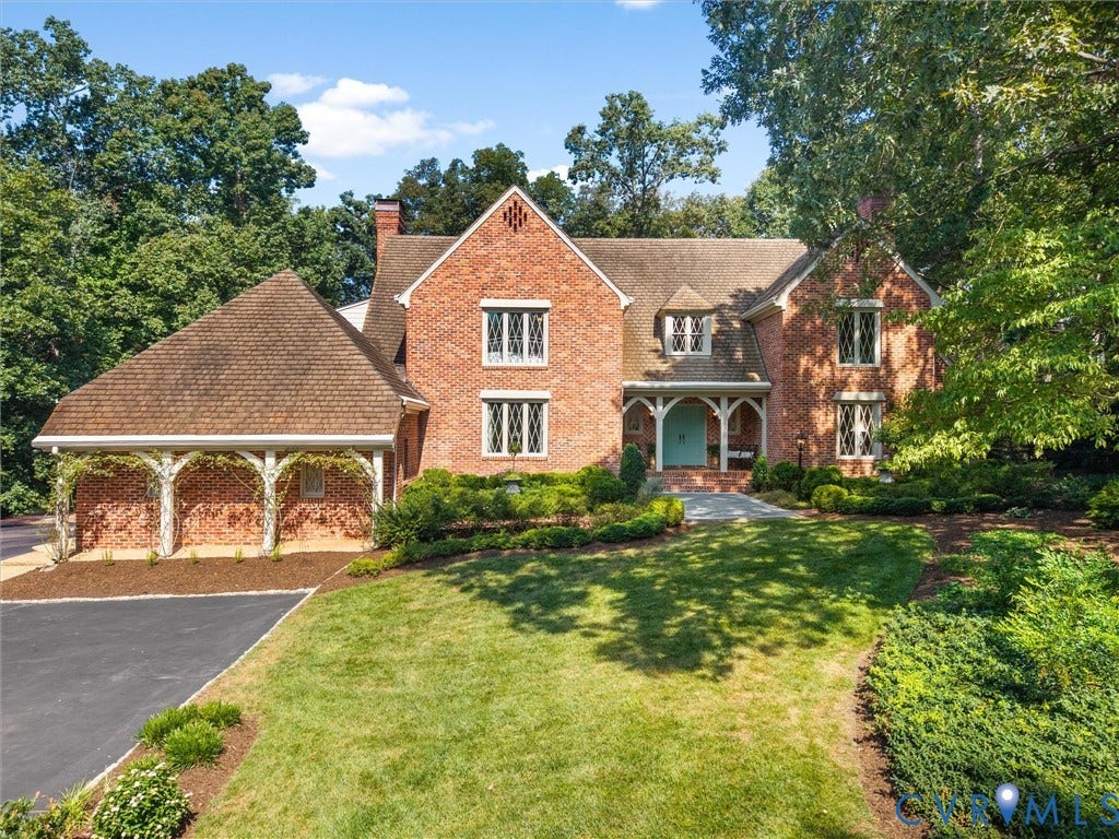 500 Kilmarnock Drive, Collegiate Area, Henrico, VA 23229 Brick exterior with multiple gables, diamond-pane windows, covered entry porch, asphalt driveway, and mature landscaping