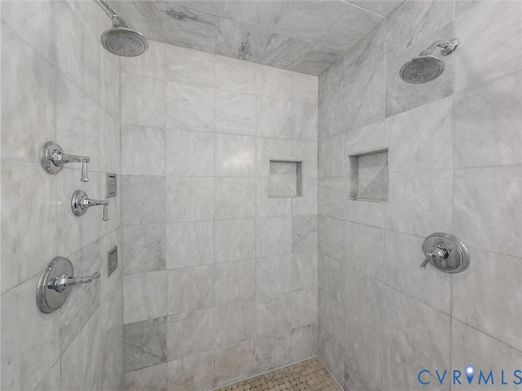 500 Kilmarnock Drive, Collegiate Area, Henrico, VA 23229 Tiled shower enclosure featuring dual shower heads, multiple control valves, and recessed shelving