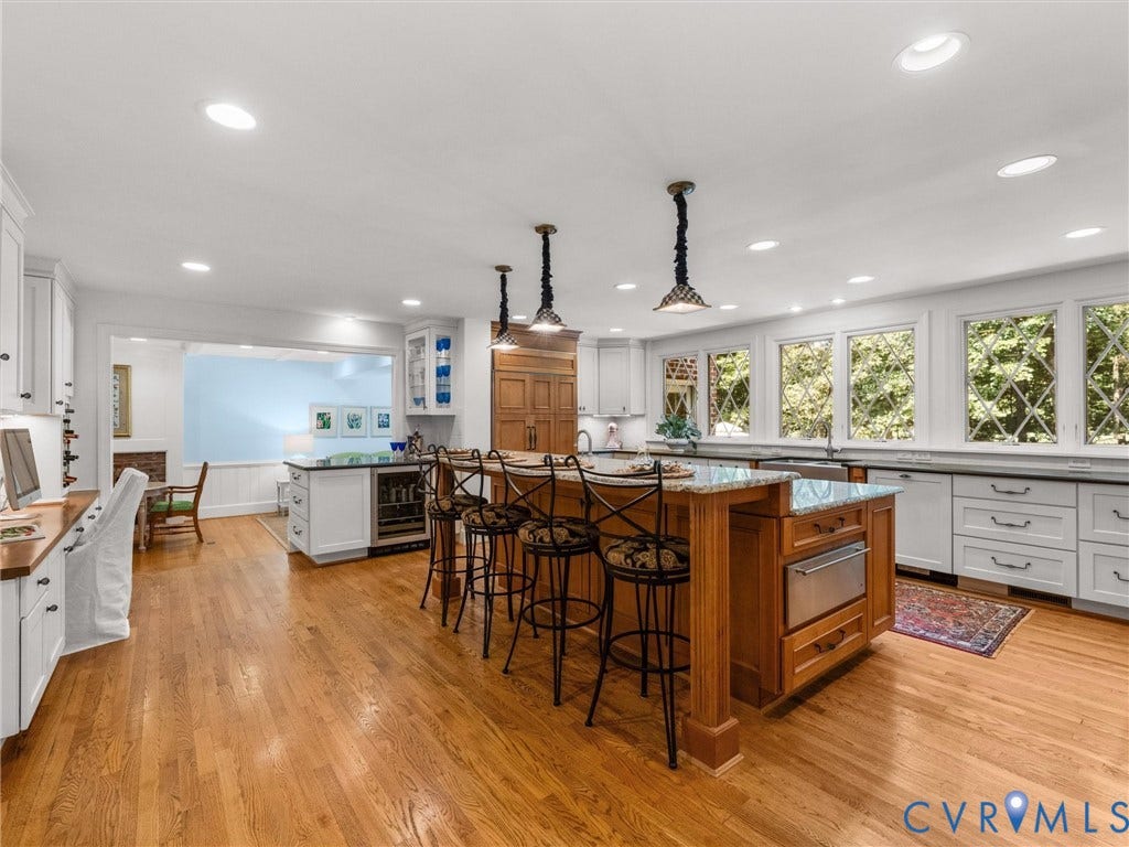 500 Kilmarnock Drive, Collegiate Area, Henrico, VA 23229 Hardwood flooring throughout the kitchen, complemented by a large center island with integrated appliances and pendant lighting