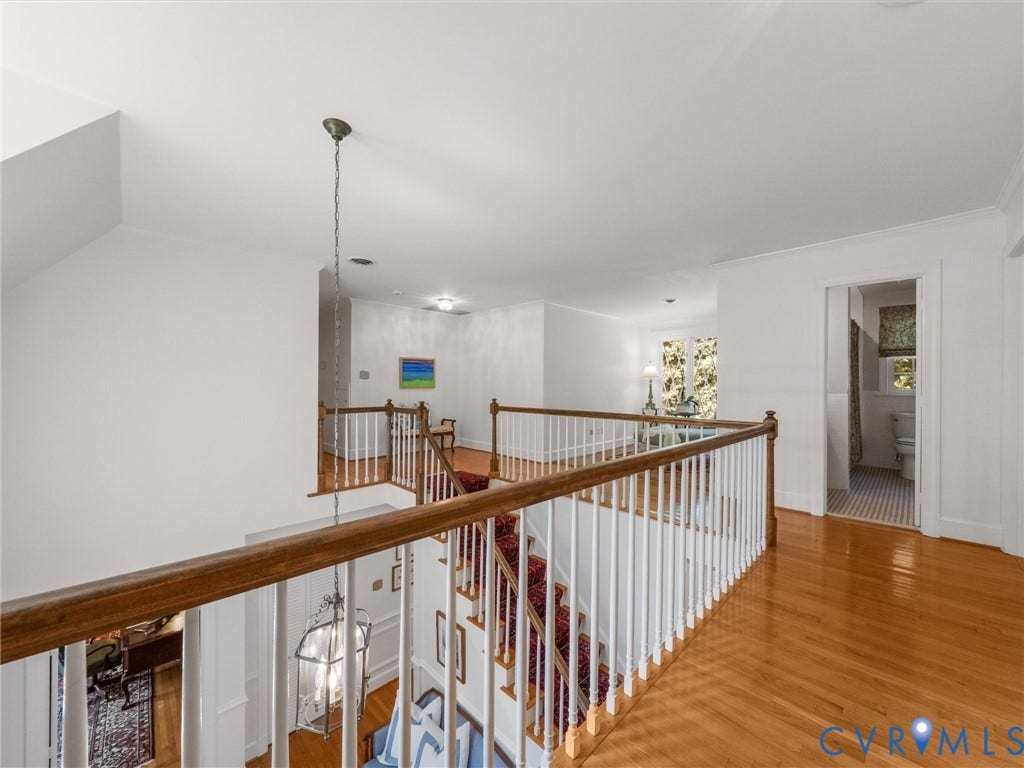 500 Kilmarnock Drive, Collegiate Area, Henrico, VA 23229 Hardwood flooring, painted white balusters, wooden handrail, and chandelier