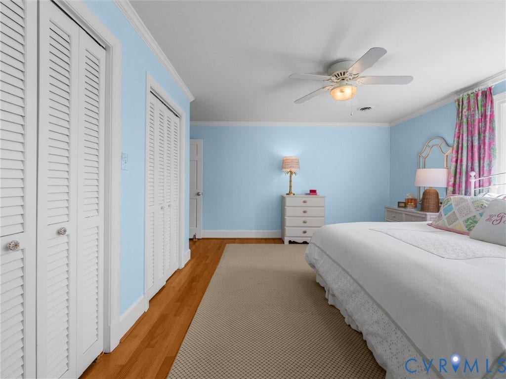 500 Kilmarnock Drive, Collegiate Area, Henrico, VA 23229 Hardwood flooring, crown molding, white louvered bifold doors, and a ceiling fan with light fixture