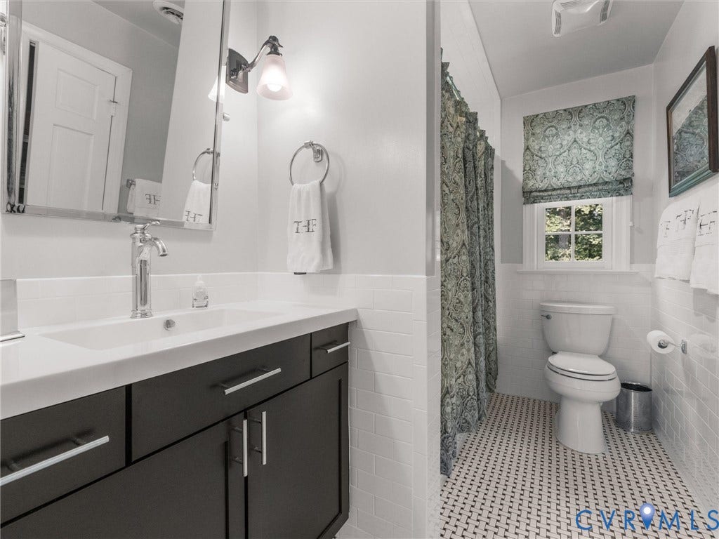 500 Kilmarnock Drive, Collegiate Area, Henrico, VA 23229 Vanity with a white countertop and dark cabinetry, chrome faucet, wall-mounted mirror, and tile flooring