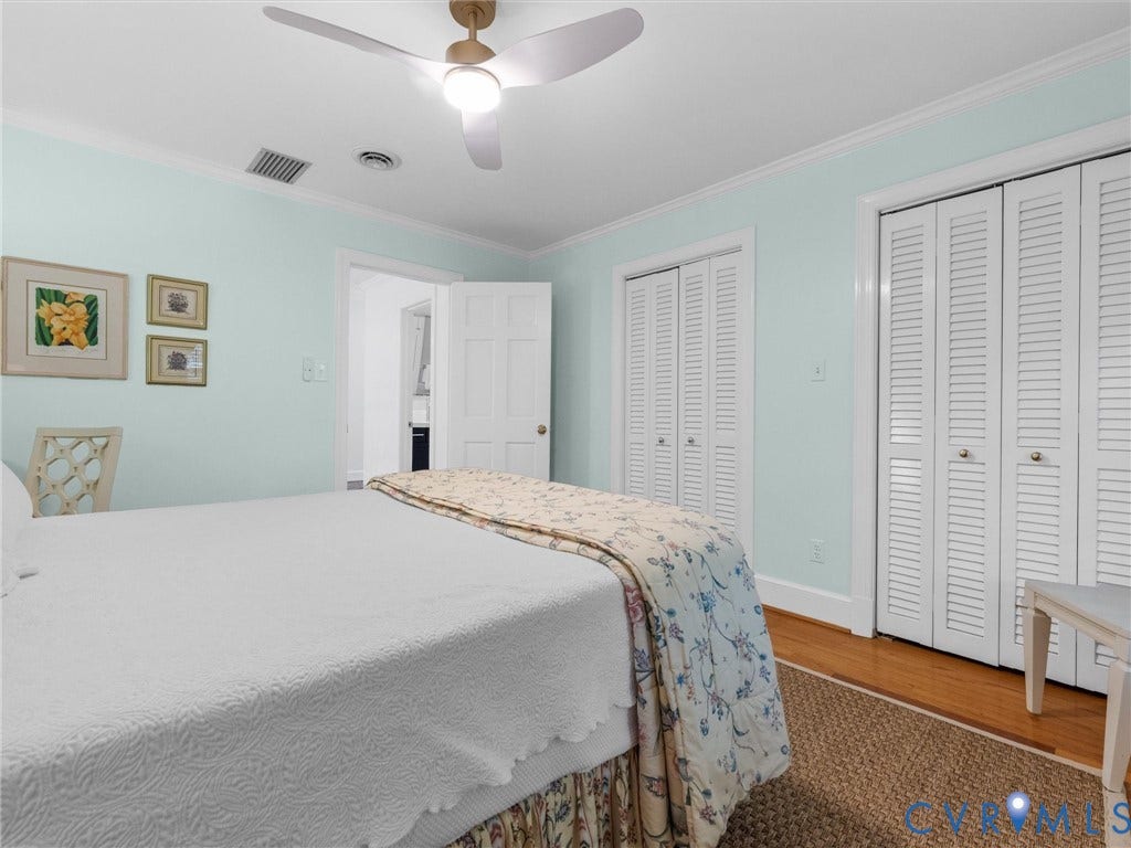 500 Kilmarnock Drive, Collegiate Area, Henrico, VA 23229 Integrated ceiling fan, crown molding, wood-finish flooring, and white louvered bifold closet doors