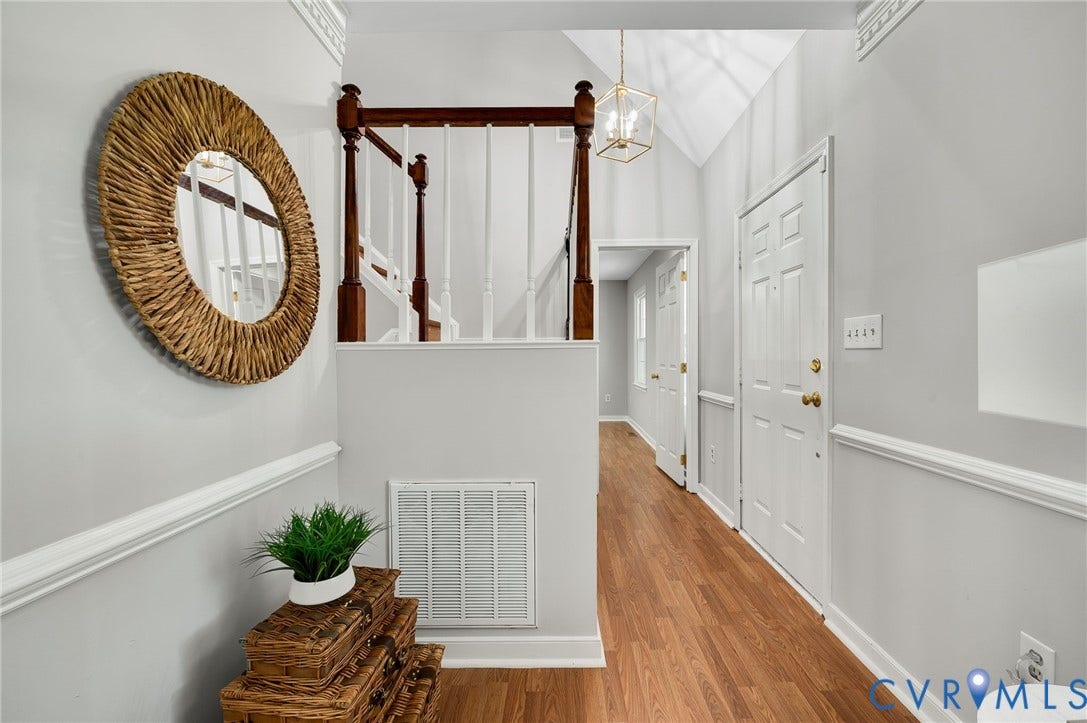 Wood-finish flooring throughout, with wainscoting and crown molding accents