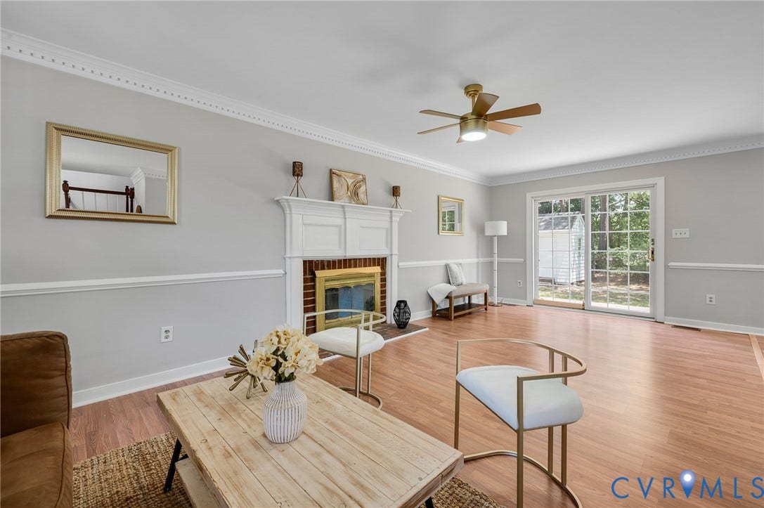 Wood-finish flooring, white chair rail molding, and crown molding