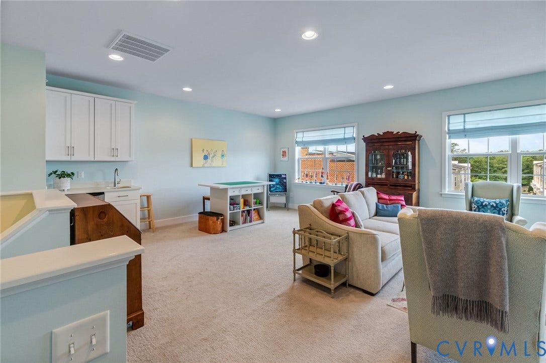 Another large living /entertaining space on the 3rd floor with built ins and a wet bar.