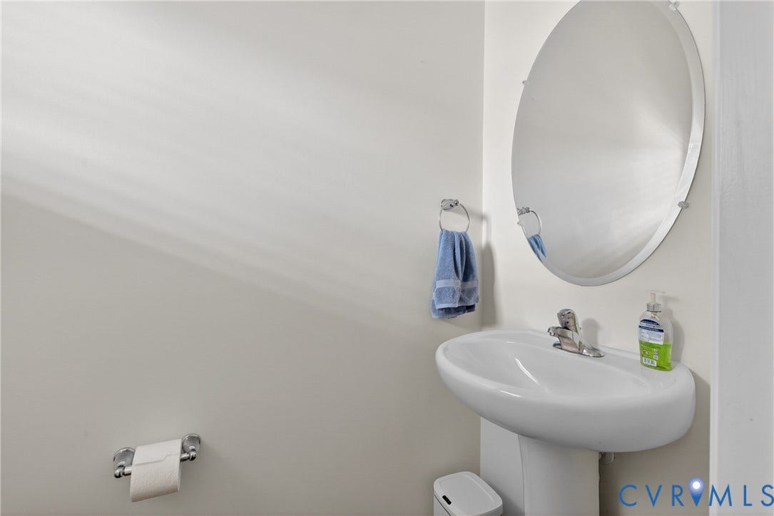 3700 Irby Pond Drive, Midlothian, VA 23112 Pedestal sink with chrome faucet, oval mirror, and chrome towel ring