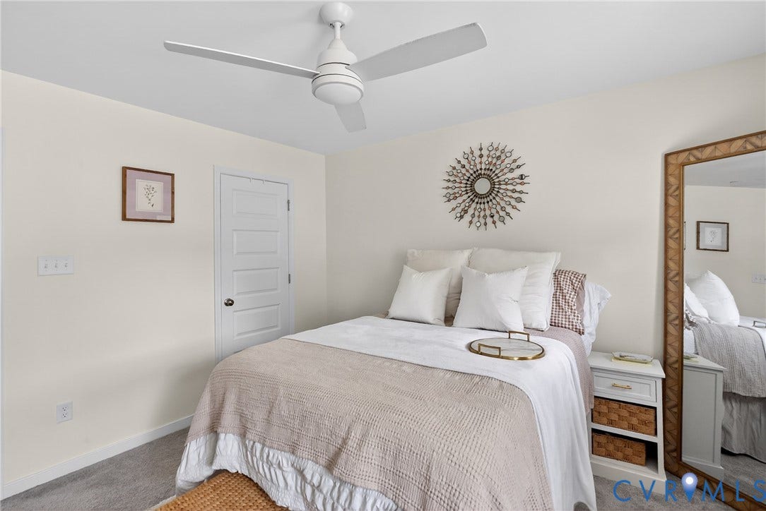 3700 Irby Pond Drive, Midlothian, VA 23112 Recessed panel door with dark hardware, ceiling fan with light, and light-toned carpeting
