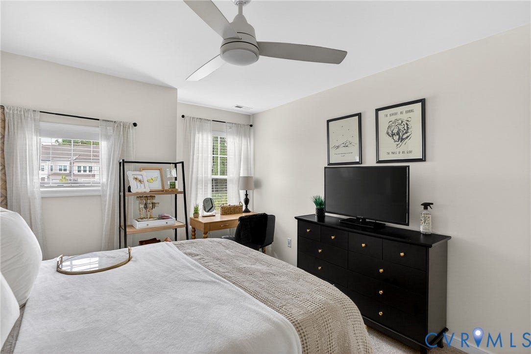 3700 Irby Pond Drive, Midlothian, VA 23112 White walls featuring two windows with white window treatments, a ceiling fan, and light-colored carpeting