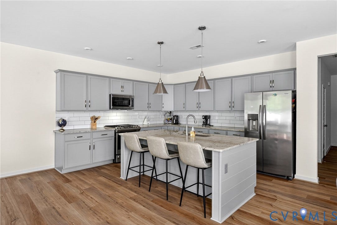 3700 Irby Pond Drive, Midlothian, VA 23112 Kitchen featuring gray cabinetry, stainless steel appliances, a center island with pendant lighting, stone countertops, and wood-finish flooring