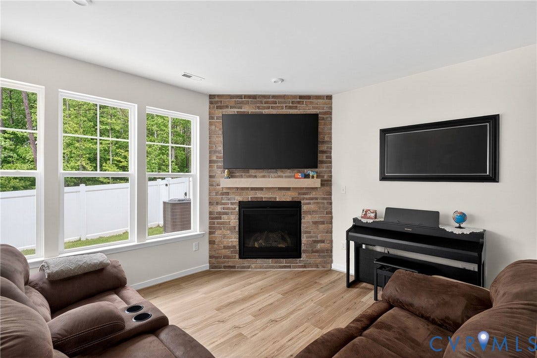 3700 Irby Pond Drive, Midlothian, VA 23112 Corner-set fireplace with a stone surround and wood mantel