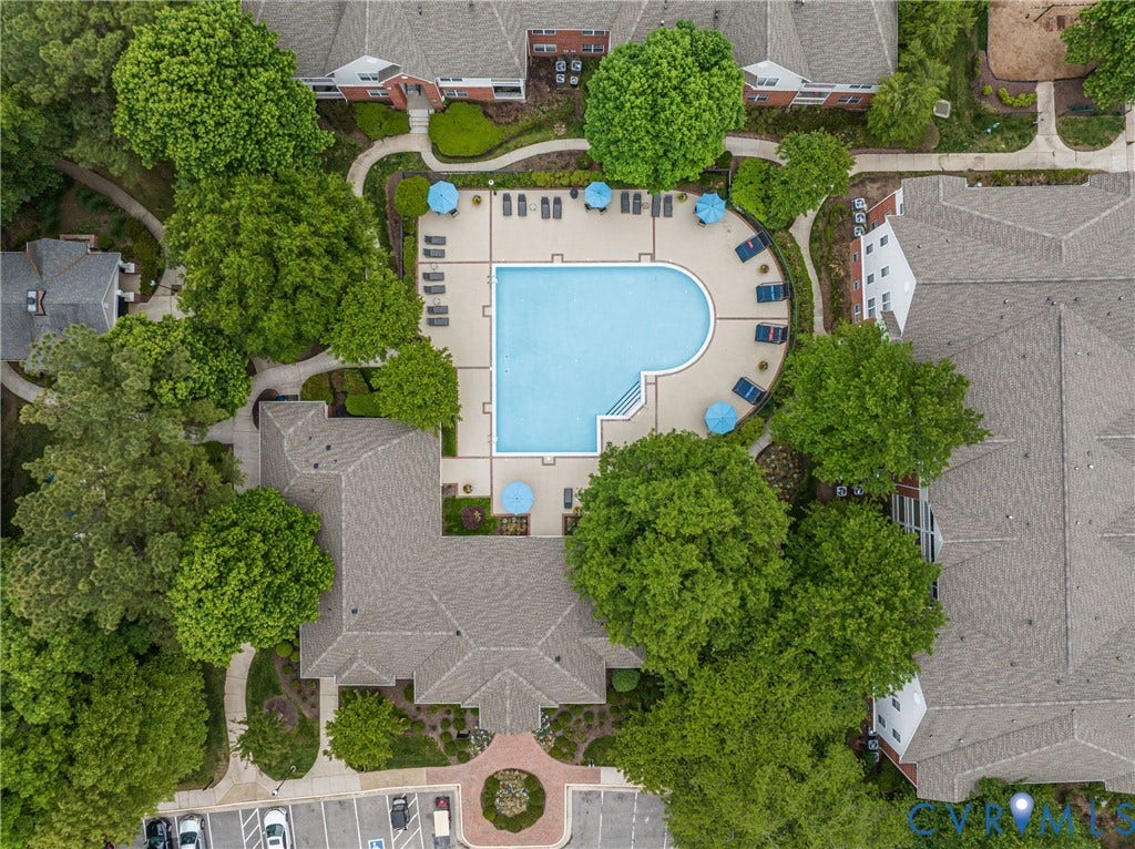 3700 Irby Pond Drive, Midlothian, VA 23112 Central swimming pool with a surrounding patio, mature trees, and multiple buildings